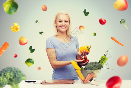 健康的饮食,烹饪,素食,饮食人们的微笑的轻女人与碗蔬菜灰色背景与下降的蔬菜图片