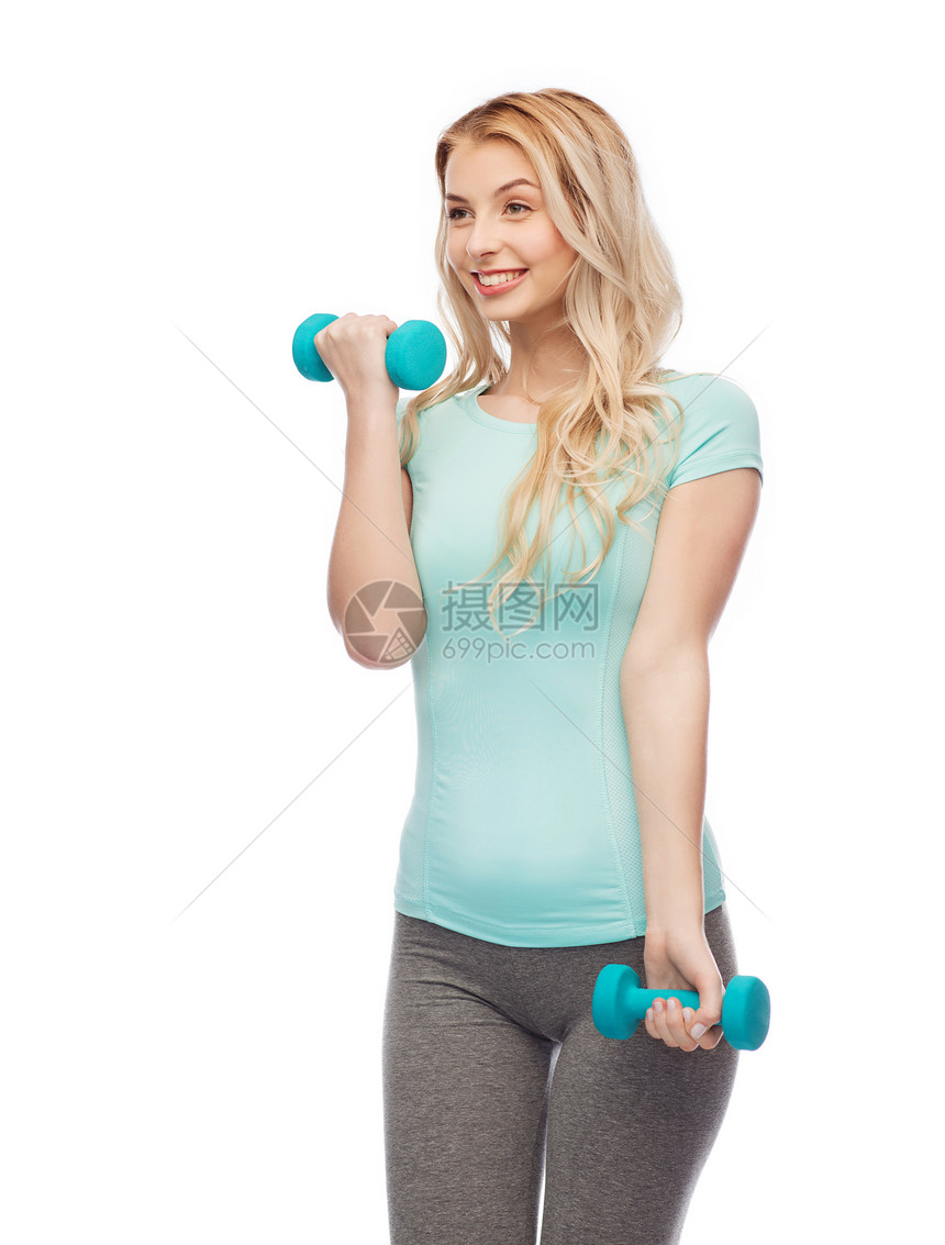 健身,运动,锻炼人的微笑美丽的运动女人与哑铃图片