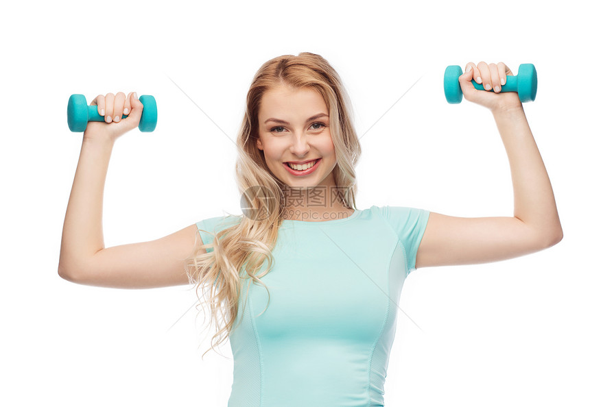 健身,运动,锻炼人的微笑美丽的运动女人与哑铃图片