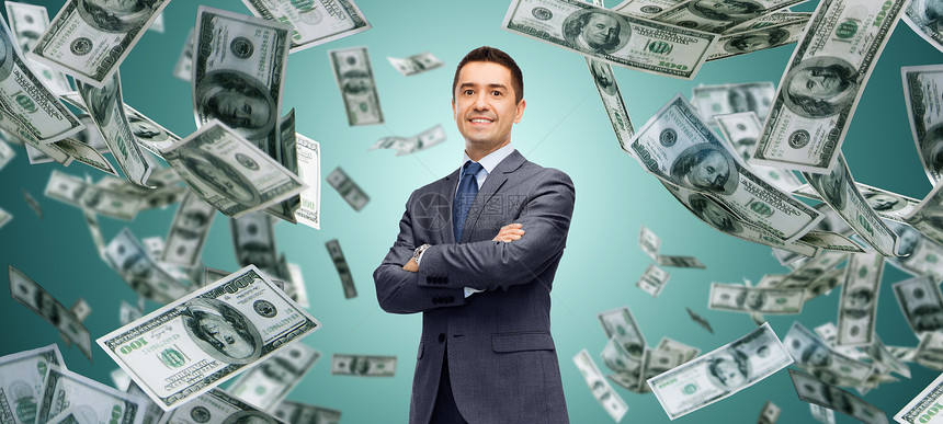 商业,金融,投资,经济人的快乐的商人超过美元现金钱雨绿色背景图片