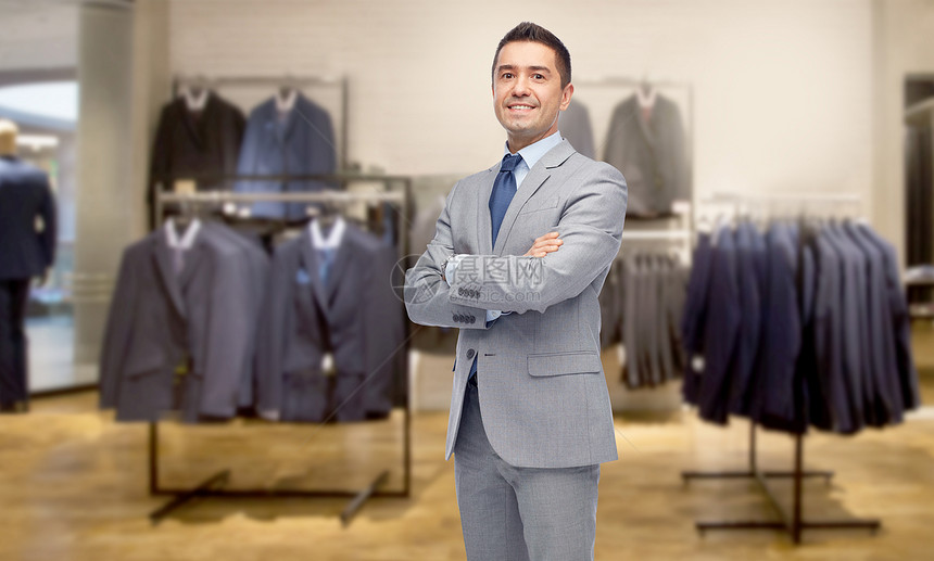 商业,人,男装,销售服装快乐的微笑商人穿西装服装店的背景图片