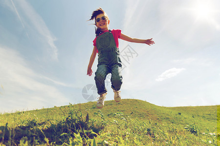 夏天,童,休闲人的快乐的小女孩跳过绿色的田野蓝天户外图片