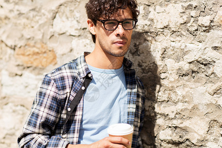 生活方式,饮料人的戴眼镜的人喝咖啡次纸杯街道墙上图片
