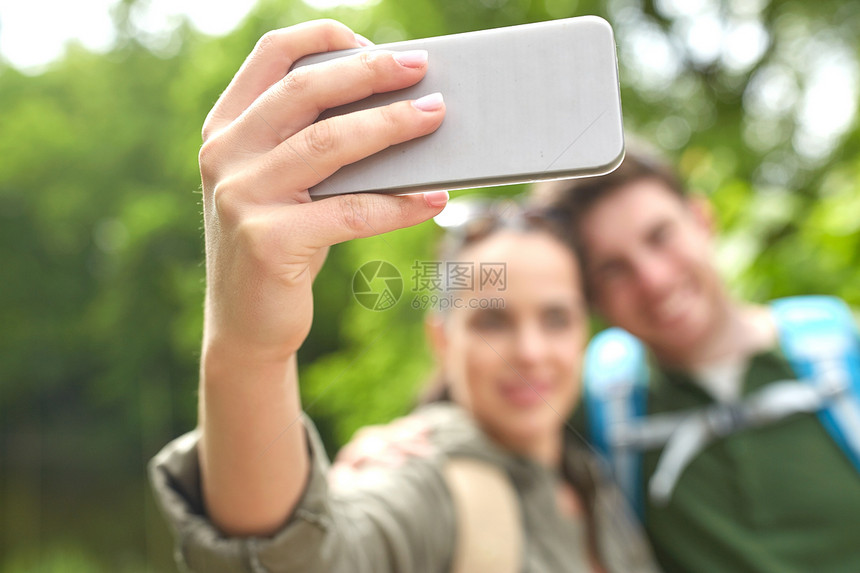 旅行,徒步旅行,旅游,技术人的亲密的幸福夫妇与背包采取自拍智能手机自然界图片