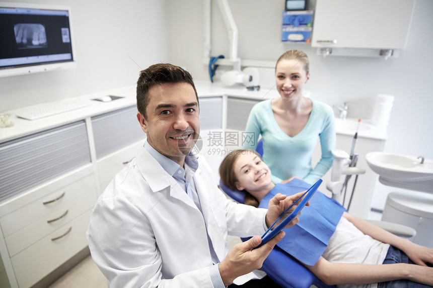 医学,口腔医学,技术保健快乐的男牙医与平板电脑,病人女孩她的母亲牙科诊所办公室图片