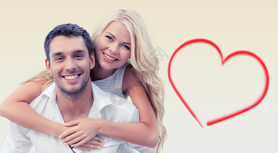 假期,情人节,约会爱情快乐的夫妇米色背景红色心形上玩得很开心图片