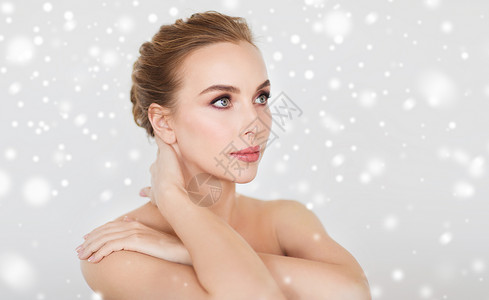 美丽,人,冬天身体护理的美丽的轻女人的脸手灰色的背景雪背景图片