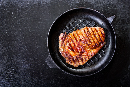 烤肉平底锅黑暗的背景,顶部的视图图片