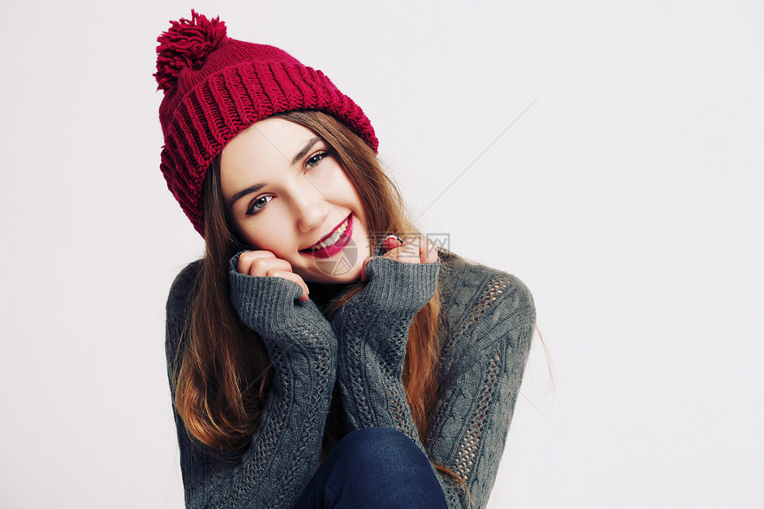 穿着针灰色毛衣BeanieMarsala帽子的趣的时髦女孩明亮的嘴唇,玩得开心冬季时尚休闲服装图片