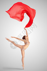 布料鞋女素材位优雅的女古典芭蕾舞穿着米色内衣,站条腿上,站阿拉伯风格的位置,中灯光工作室背景上扔红色的布料背景