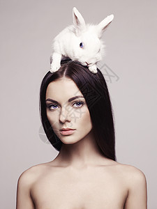 兔子头工作室时尚肖像美丽的女士与白兔背景