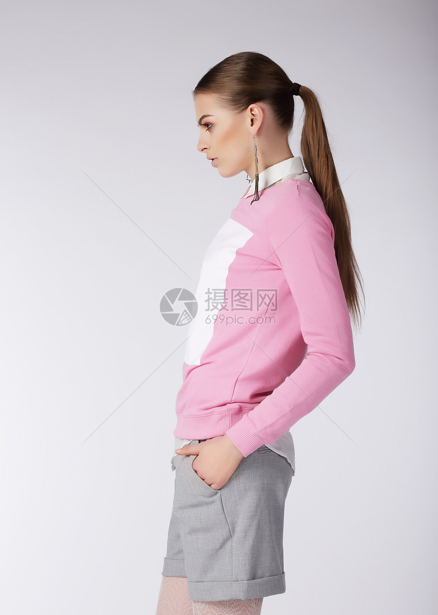 时尚的女孩穿着短裤工作室摆姿势图片