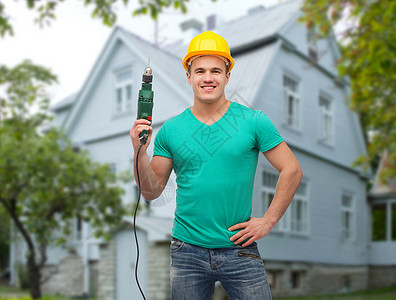 维修,建筑,人,建筑维修微笑男手动工人保护头盔持电钻房子的背景图片