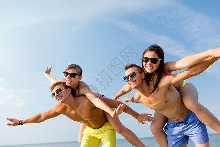友谊,海洋,暑假,假期人们的群微笑的朋友穿着泳装太阳镜海滩上玩得很开心图片