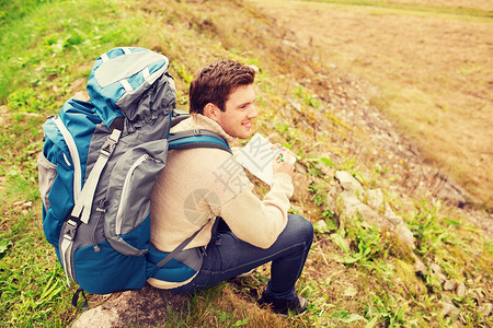冒险,旅行,旅游,徒步旅行人的微笑的人,背包坐地上图片