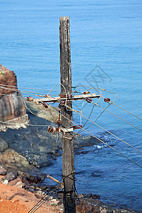旧的混凝土电杆电力线靠海图片