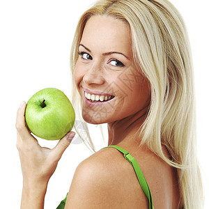 轻微笑的女人着绿色的苹果,孤立白色上图片