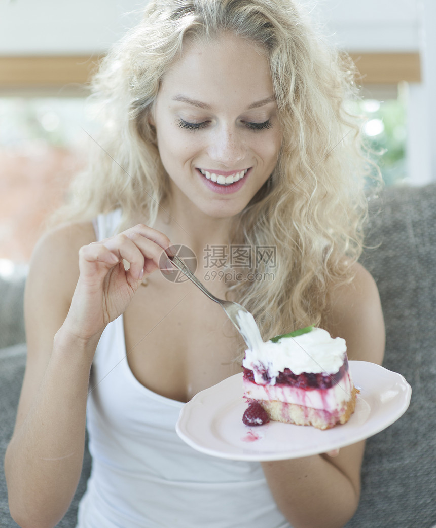 家里覆盆子蛋糕的漂亮女人图片
