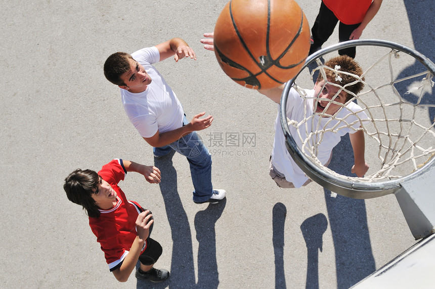 轻男孩户外打篮球,长阴影鸟瞰视角图片