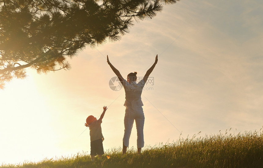 快乐的轻女子母亲与美丽的孩子玩耍户外图片