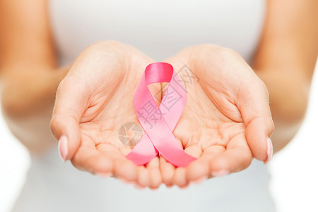 治疗癌症医疗保健医学妇女手粉红色乳腺癌意识丝带背景