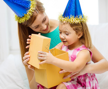 家庭,孩子,庆祝,节日,生日快乐的人的快乐的母亲女儿戴着蓝色的帽子礼品盒图片