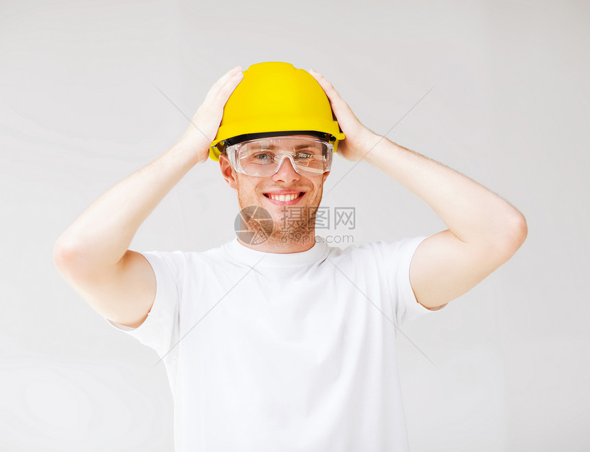 建筑,开发,建筑男建筑工人安全眼镜黄色头盔的图片图片