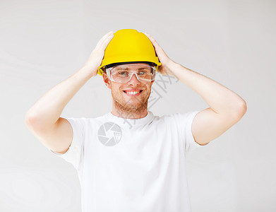 建筑,开发,建筑男建筑工人安全眼镜黄色头盔的图片图片