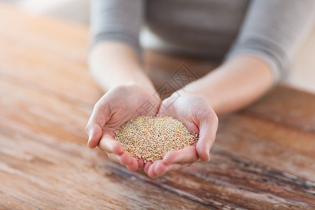 藜麦种子烹饪家庭女杯手与藜麦背景