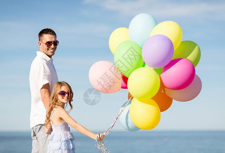 暑假,庆祝,孩子家庭的快乐的父亲女儿海边用五颜六色的气球图片