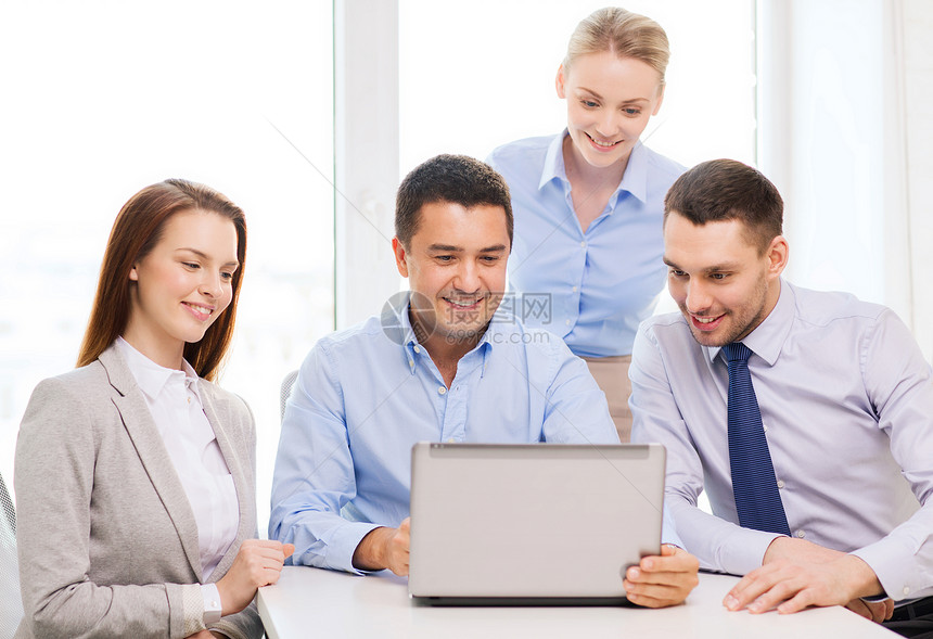 业务办公室微笑的业务队与笔记本电脑办公室工作图片