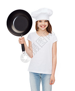 微笑的小女孩戴着煎锅的厨师帽图片