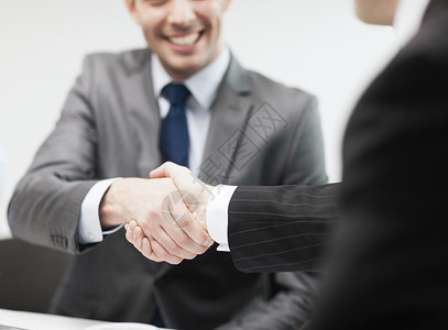 商业办公室两个商人办公室握手背景图片