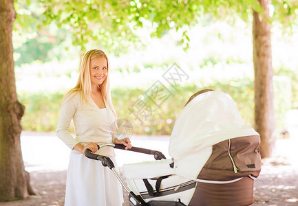家庭,孩子父母的快乐的母亲与婴儿车公园图片
