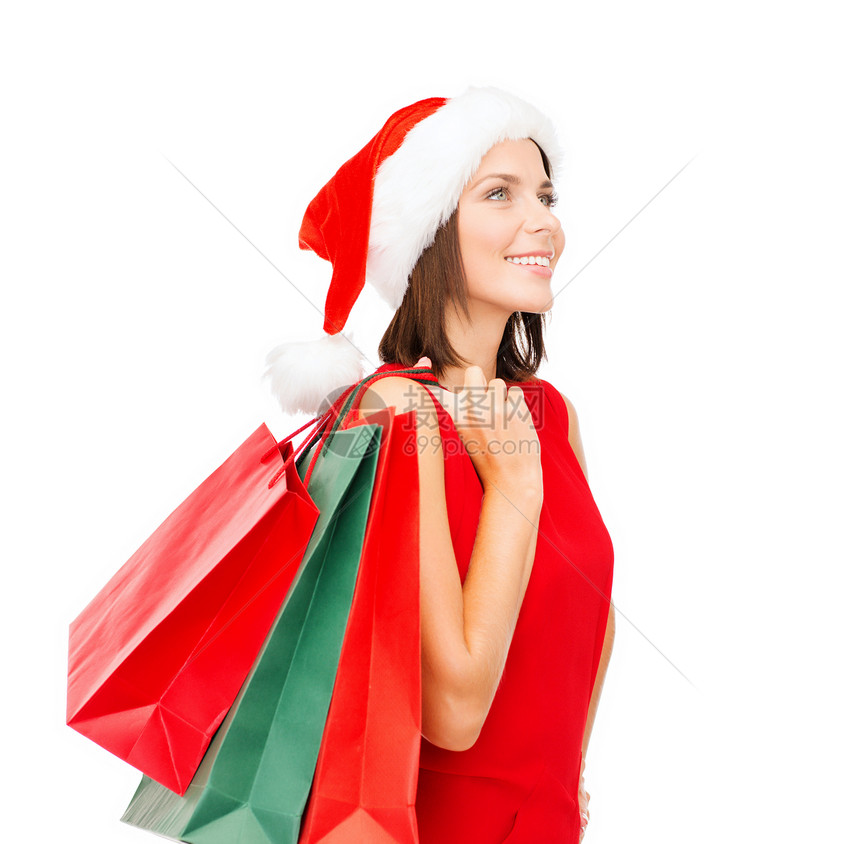 销售,礼物,诞节,诞节微笑的女人穿着红色连衣裙诞老人助手帽子与购物袋图片