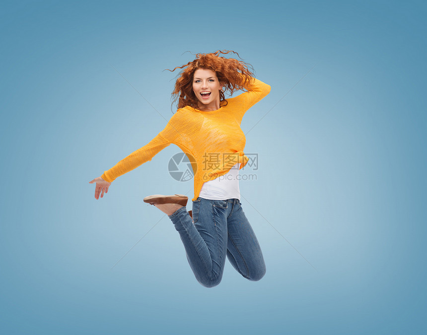 幸福自由运动人的微笑的轻女人蓝色背景上跳跃图片