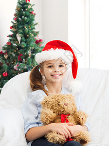 假期,礼物,童人的微笑的小女孩与泰迪熊玩具客厅诞树的背景图片