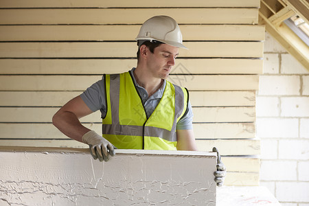 建筑工人将保温板安装新家的屋顶上图片