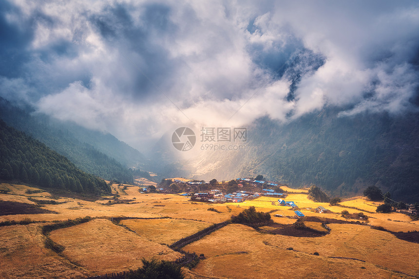 日落时,山上个令人惊奇的小村庄被阳光照亮风景与房屋,田野与黄草,阳光山脉与绿色森林尼泊尔乡村景色喜马拉雅图片