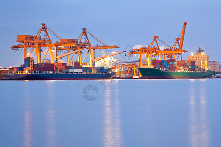大型终端大型集装箱货运船与工作重机船厂黄昏,为物流进口出口背景背景
