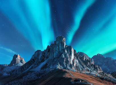 欧洲的夜晚,北极光山上北极光星空极地的灯光高高的岩石美丽的景观与极光,道路,建筑山上,山脊旅行背景图片
