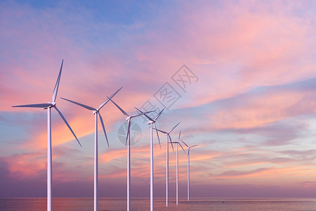 日落时,海上的风力发电机涡轮机图片
