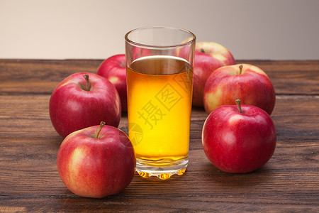 璃状的木制背景上的杯苹果汁红苹果背景