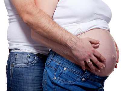 男人女人的手白色的怀孕的肚子上图片