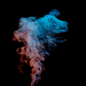 蒸腾黑色背景上的美丽烟雾,烟雾的运动,黑色背景上五颜六色的魔法烟雾的抽象纹理黑暗的背景上吸烟背景