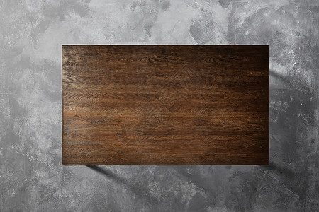 混凝土背景平上棕色木桌的顶部视图混凝土背景上的木桌图片