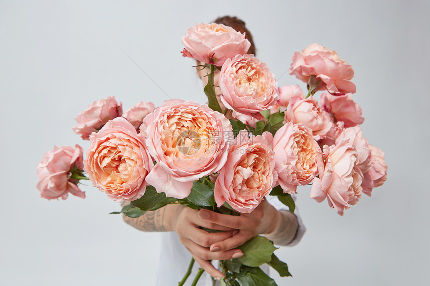 轻女孩手捧大粉红色玫瑰的情人节母亲节新鲜的粉红色玫瑰,抱着个女孩图片