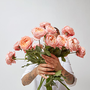 女人捧着美丽的粉红色玫瑰,情人节新鲜的粉红色玫瑰,抱着个女孩图片