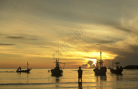 太阳鱼早晨的海洋生活与船渔夫,日出背景