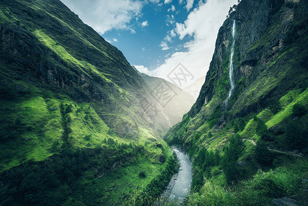 比利茨基戏剧的美丽的山覆盖着绿色的草喜怒无常的景观与山谷,河流,瀑布,草地森林,天空与云夏季尼泊尔阴天喜马拉雅山旅行自然背景